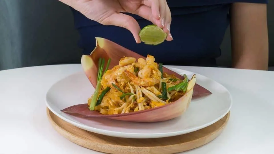 The dish itself is a tantalizing blend of flavors: tender noodles, succulent shrimp, and vibrant garnishes